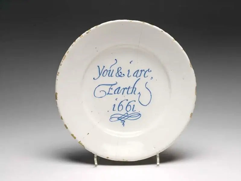 White plate with blue text 'You & I are Earth 1661' on a gray background
